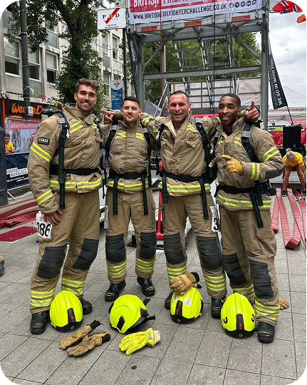 Firefighters posing together after tower challenge competition event.