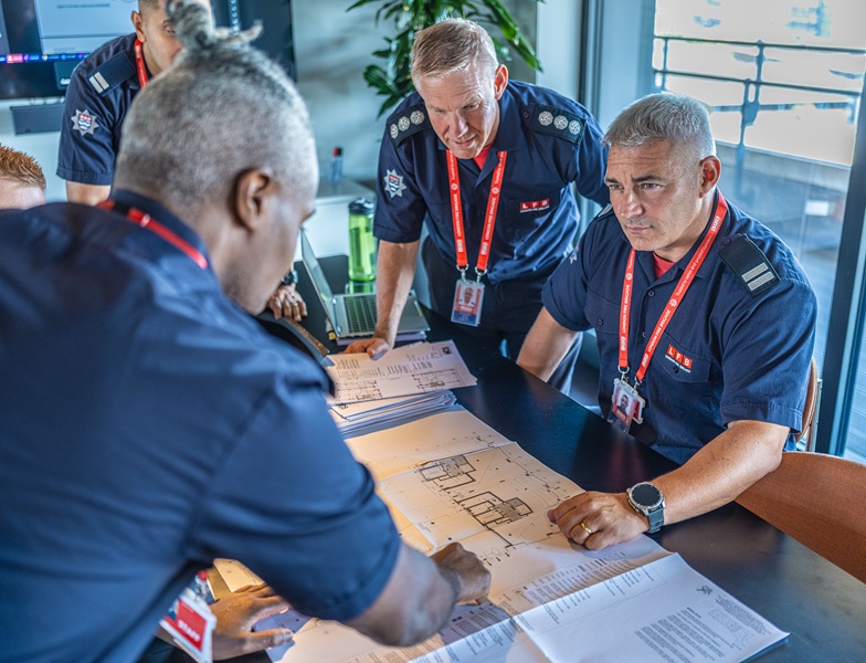 A group of firefighters is having a discussion